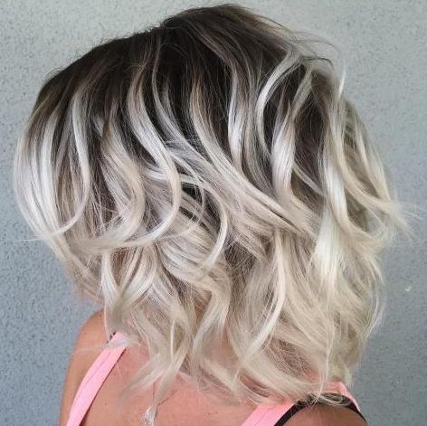 Short platinum hair with dark roots